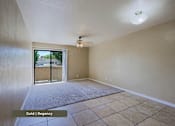 Thumbnail 33 of 51 - A room with a sliding glass door leading to a balcony.
