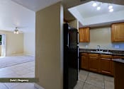 Thumbnail 27 of 51 - A kitchen with a black refrigerator and wooden cabinets.