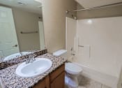 Thumbnail 2 of 94 - A bathroom with a sink, toilet, and bathtub.