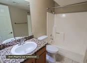 Thumbnail 26 of 51 - A bathroom with a sink, toilet, and bathtub.