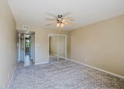Thumbnail 1 of 94 - A room with a ceiling fan and carpeted floor.