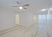 Thumbnail 6 of 19 - A room with a ceiling fan and light fixture.