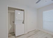 Thumbnail 8 of 19 - a small laundry room with a washer and dryer
