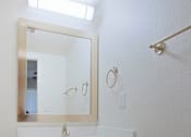 Thumbnail 12 of 19 - A white bathroom with a sink and mirror.