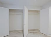 Thumbnail 11 of 19 - A white room with two open doors.
