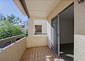 Thumbnail 22 of 36 - A balcony with a glass door and a window.