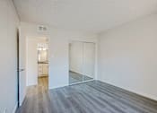 Thumbnail 21 of 36 - A room with a white door and a white wall.