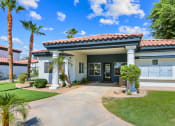 Thumbnail 3 of 18 - a house with a driveway and palm trees in front of it