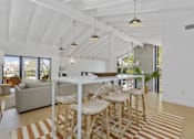 Thumbnail 2 of 28 - A white dining room with a long table and chairs.