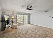 Thumbnail 15 of 16 - A room with a ceiling fan and a window with blinds.