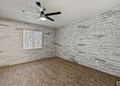 Thumbnail 16 of 16 - A room with a ceiling fan and a window with a white frame.