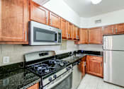 Thumbnail 6 of 19 - renovated kitchen with stainless steel appliances and oak cabinetry at clarence house apartments in van ness washington dc