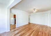 Thumbnail 19 of 29 - vacant living area with hardwood floors, ceiling fan and view of kitchen at the frontenac apartments in van ness washington dc