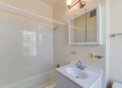 Thumbnail 24 of 39 - bathroom with toilet, vanity, tub, and medicine cabinet at twin oaks apartments columbia heights washington dc