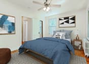 Thumbnail 9 of 17 - bedroom with bed nightstand, large windows and hard wood floors at 1400 van buren apartments in washington dc