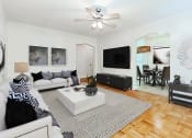 Thumbnail 5 of 17 - living area with sofa, love seat, hardwood floors and view of dining area at  1400 van buren apartments washington dc