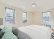 Thumbnail 11 of 19 - bedroom with bed, windows and hardwood floors 1401 sheridan apartments in washington dc