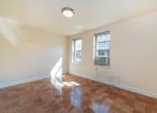 Thumbnail 5 of 19 - vacant living area with hardwood flooring and large windows at 1401 Sheridan apartments in washington dc
