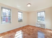 Thumbnail 12 of 19 - vacant living area with hardwood flooring and large windows at 1401 Sheridan apartments in washington dc