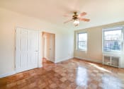 Thumbnail 6 of 19 - vacant living area with hardwood flooring, ceiling fan, and large windows  at 1401 sheridan apartments in washington dc