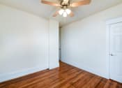 Thumbnail 18 of 21 - vacant bedroom with hardwood flooring and ceiling fan at the cortland apartments in washington dc