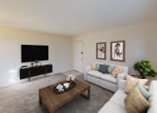 Thumbnail 3 of 15 - living area with sofa, coffee table, credenza, tv and view of front entrance at manor village  tax credit apartments in washington dc