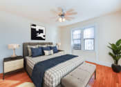 Thumbnail 11 of 23 - bedroom with bed, nightstand, hardwood floors, ceiling fan and large windows at chatham courts apartments in washington dc