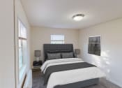 Thumbnail 5 of 15 - bedroom with bed, nightstand, windows and lighting at manor village tax credit apartments in washington dc
