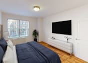 Thumbnail 8 of 19 - bedroom with bed, night stands, dresser, tv and large window at clarence house apartments in washington dc
