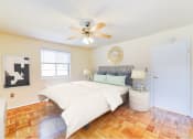 Thumbnail 8 of 15 - bedroom with bed, nightstands, hardwood flooring and ceiling fan at new horizon apartments in washington dc