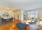 Thumbnail 6 of 15 - living area with sofa, coffee table, large windows, hardwood flooring and view of dining area at new horizon apartments in washington dc