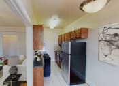 Thumbnail 3 of 28 - living area with sofa, coffee table and view of kitchen at the klingle apartments in washignton dc
