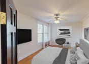 Thumbnail 3 of 21 - bedroom with bed, desk, large windows and tv at the cortland apartments in washington dc