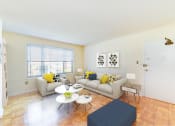Thumbnail 4 of 15 - living area with sofa, coffee table, hardwood flooring, and large windows at new horizon apartments in washington dc