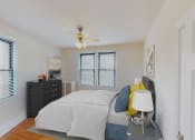 Thumbnail 7 of 28 - bedroom with bed, nighstands, dresser, large windows and ceiling fan at the klingle apartments in washignton dc