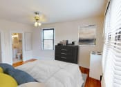 Thumbnail 6 of 28 - bedroom with bed, dresser, closet and view of bathroom at the klingle apartments in washignton dc