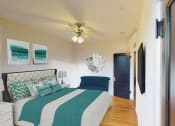 Thumbnail 5 of 21 - bedroom with bed, nightstand, hardwood floors, ceiling fan and large windows at the cortland apartments in washington dc