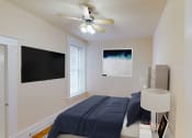 Thumbnail 7 of 35 - bedroom with bed, tv, nightstand and large window at dupont apartments in washington dc