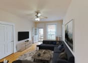 Thumbnail 6 of 35 - living area with sofa, coffee table, credenza, tv, ceiling fan and view of balcony at dupont apartments in washington dc
