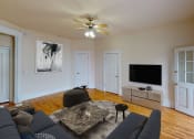 Thumbnail 5 of 35 - living area with sofa, coffee table, credenza, tv, and hardwood floors at dupont apartments in washington dc