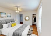 Thumbnail 2 of 21 - bedroom with bed, nightstands, ceiling fan, large closet and hardwood flooring at 6100 14th Street apartments in washington dc