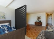 Thumbnail 11 of 47 - studio apartments showing bed, sofa and front entrance at brunswick house apartments in dupont circle washington dc
