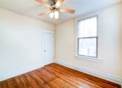 Thumbnail 17 of 21 - vacant bedroom with hardwood flooring and ceiling fan at the cortland apartments in washington dc