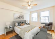 Thumbnail 10 of 26 - bedroom with bed, nightstand, hardwood floors, ceiling fan and large windows at 2800 ontario road apartments in washington dc