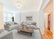 Thumbnail 4 of 26 - living area with sofa, coffee table, hardwood floors, large windows and ceiling fan  at 2800 ontario road apartments in washington dc