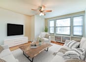 Thumbnail 2 of 26 - living area with sofa, coffee table, credenza, tv, hardwood floors and ceiling fan at  2701 Connecticut apartments in washington dc