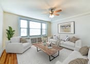 Thumbnail 1 of 26 - living area with sofa, coffee table, large windows and hardwood flooring at  2701 Connecticut apartments in washington dc
