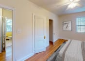 Thumbnail 6 of 27 - a bedroom with a large bed and a ceiling fan