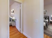 Thumbnail 4 of 27 - a bedroom with a bed and a door that leads to a living room