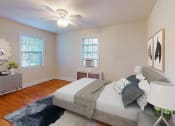 Thumbnail 5 of 27 - a bedroom with a bed and two windows